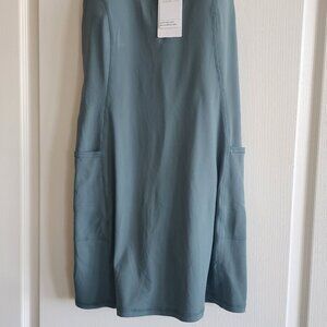 Courtside utility bra dress with pockets and built in shorts. Size large,  green